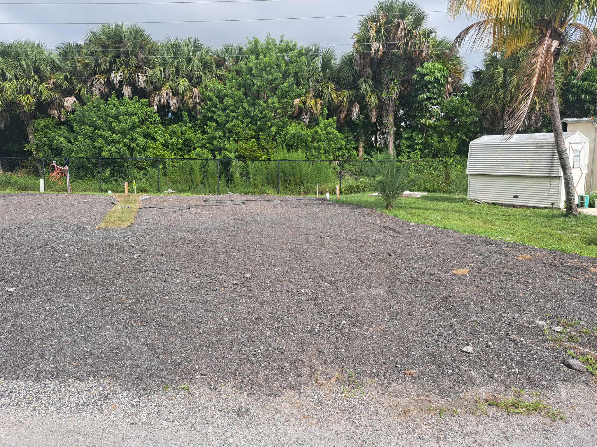 Boat and RV storage area with palm trees